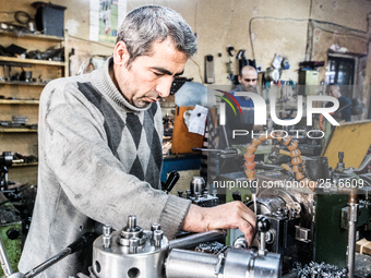 Workers are processing metal to make fasteners for industrial use in a old "han" factory in Istanbul, Turkey, 25 February 2018. This buildin...