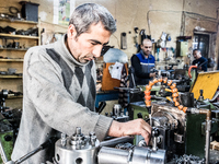 Workers are processing metal to make fasteners for industrial use in a old "han" factory in Istanbul, Turkey, 25 February 2018. This buildin...