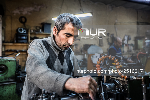 Workers are processing metal to make fasteners for industrial use in a old "han" factory in Istanbul, Turkey, 25 February 2018. This buildin...