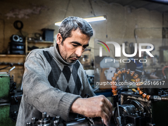 Workers are processing metal to make fasteners for industrial use in a old "han" factory in Istanbul, Turkey, 25 February 2018. This buildin...