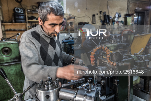 Workers are processing metal to make fasteners for industrial use in a old "han" factory in Istanbul, Turkey, 25 February 2018. This buildin...