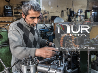 Workers are processing metal to make fasteners for industrial use in a old "han" factory in Istanbul, Turkey, 25 February 2018. This buildin...