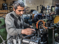 Workers are processing metal to make fasteners for industrial use in a old "han" factory in Istanbul, Turkey, 25 February 2018. This buildin...