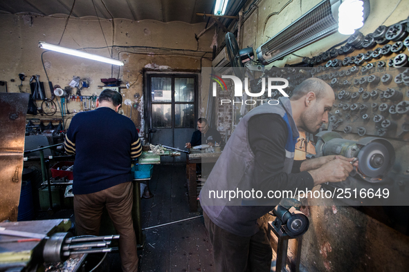 Workers are processing metal to make fasteners for industrial use in a old "han" factory in Istanbul, Turkey, 25 February 2018. This buildin...