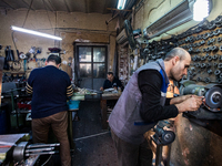 Workers are processing metal to make fasteners for industrial use in a old "han" factory in Istanbul, Turkey, 25 February 2018. This buildin...