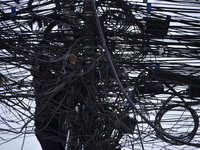 An electrician of Nepal Electricity Authority (NEA) arranging Electric wires at Pulchowk, Patan, Nepal on Tuesday, February 27, 2018. (