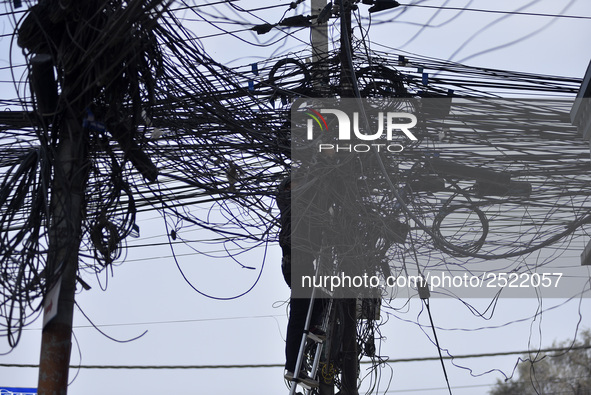 An electrician of Nepal Electricity Authority (NEA) arranging Electric wires at Pulchowk, Patan, Nepal on Tuesday, February 27, 2018. 