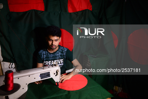 A worker is sewing the national flag of Bangladesh for upcoming event Independence Day on March 26 in Dhaka, Bangladesh, on March 05, 2018....