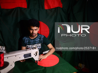 A worker is sewing the national flag of Bangladesh for upcoming event Independence Day on March 26 in Dhaka, Bangladesh, on March 05, 2018....