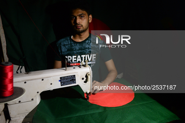 A worker is sewing the national flag of Bangladesh for upcoming event Independence Day on March 26 in Dhaka, Bangladesh, on March 05, 2018....