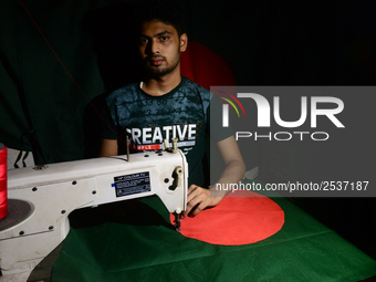 A worker is sewing the national flag of Bangladesh for upcoming event Independence Day on March 26 in Dhaka, Bangladesh, on March 05, 2018....