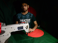 A worker is sewing the national flag of Bangladesh for upcoming event Independence Day on March 26 in Dhaka, Bangladesh, on March 05, 2018....