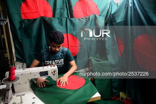 A worker is sewing the national flag of Bangladesh for upcoming event Independence Day on March 26 in Dhaka, Bangladesh, on March 05, 2018....