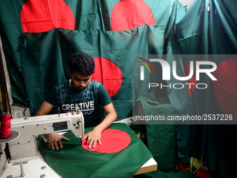 A worker is sewing the national flag of Bangladesh for upcoming event Independence Day on March 26 in Dhaka, Bangladesh, on March 05, 2018....