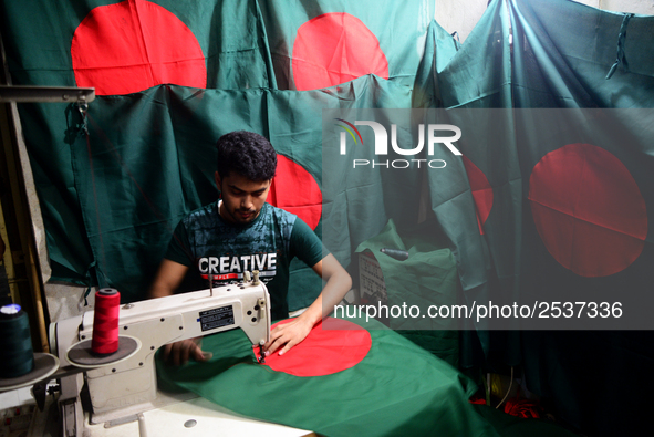 A worker is sewing the national flag of Bangladesh for upcoming event Independence Day on March 26 in Dhaka, Bangladesh, on March 05, 2018....