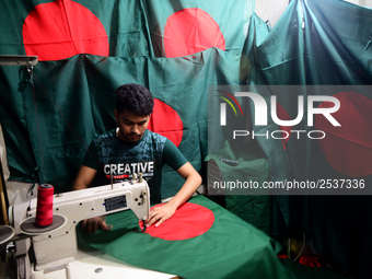 A worker is sewing the national flag of Bangladesh for upcoming event Independence Day on March 26 in Dhaka, Bangladesh, on March 05, 2018....