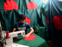 A worker is sewing the national flag of Bangladesh for upcoming event Independence Day on March 26 in Dhaka, Bangladesh, on March 05, 2018....