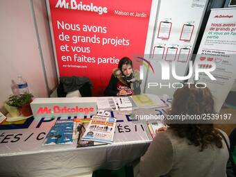 Jobseeker talks with a member of recruitment service at the "Paris pour l'emploi" (Paris for Employment) recruitment forum on March 6, 2018,...