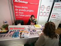 Jobseeker talks with a member of recruitment service at the "Paris pour l'emploi" (Paris for Employment) recruitment forum on March 6, 2018,...