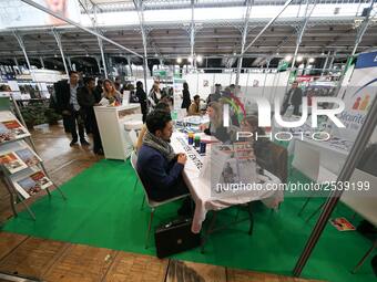 Jobseekers talk with members of French Social Security recruitment departement at the "Paris pour l'emploi" (Paris for Employment) recruitme...