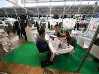 Jobseekers talk with members of French Social Security recruitment departement at the "Paris pour l'emploi" (Paris for Employment) recruitme...