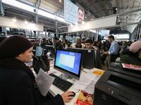 Jobseeker look at a recruitment service’s computer at the "Paris pour l'emploi" (Paris for Employment) recruitment forum on March 6, 2018, a...