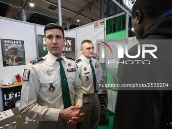 Jobseeker talks with members of French Foreign Legion recruiter staff at the "Paris pour l'emploi" (Paris for Employment) recruitment forum...