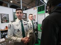 Jobseeker talks with members of French Foreign Legion recruiter staff at the "Paris pour l'emploi" (Paris for Employment) recruitment forum...