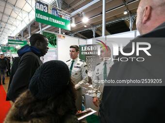 Jobseekers talk with members of French Foreign Legion recruiter staff at the "Paris pour l'emploi" (Paris for Employment) recruitment forum...