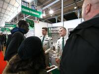 Jobseekers talk with members of French Foreign Legion recruiter staff at the "Paris pour l'emploi" (Paris for Employment) recruitment forum...