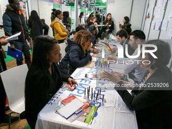 Jobseekers talk with members of recruitment services at the "Paris pour l'emploi" (Paris for Employment) recruitment forum on March 6, 2018,...