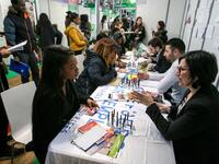 Jobseekers talk with members of recruitment services at the "Paris pour l'emploi" (Paris for Employment) recruitment forum on March 6, 2018,...