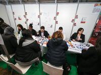 Jobseekers talks with members of recruitment services at the "Paris pour l'emploi" (Paris for Employment) recruitment forum on March 6, 2018...