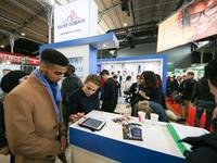 Jobseeker talks with a member of recruitment service at the "Paris pour l'emploi" (Paris for Employment) recruitment forum on March 6, 2018,...