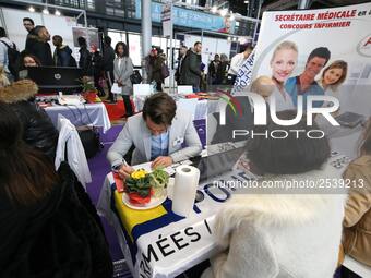 Jobseeker talks with a member of recruitment service at the "Paris pour l'emploi" (Paris for Employment) recruitment forum on March 6, 2018,...