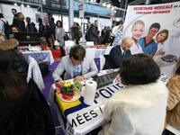 Jobseeker talks with a member of recruitment service at the "Paris pour l'emploi" (Paris for Employment) recruitment forum on March 6, 2018,...