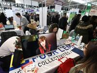 Jobseeker talks with a member of recruitment service at the "Paris pour l'emploi" (Paris for Employment) recruitment forum on March 6, 2018,...