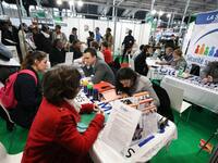 Jobseekers talk with members of French Social Security recruitment departement at the "Paris pour l'emploi" (Paris for Employment) recruitme...