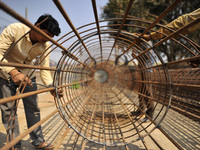 Migrated workers from India working at on-going Bridge expansion work supported by China AID at Tinkune, Kathmandu, Nepal on Thursday, March...