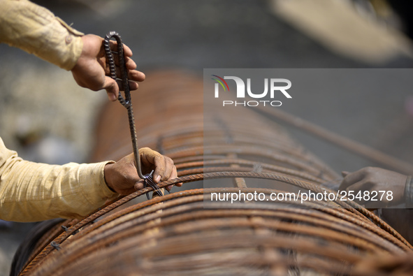 Migrated workers from India working at on-going Bridge expansion work supported by China AID at Tinkune, Kathmandu, Nepal on Thursday, March...