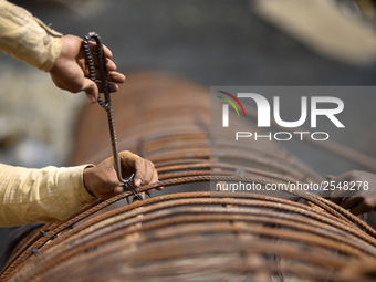 Migrated workers from India working at on-going Bridge expansion work supported by China AID at Tinkune, Kathmandu, Nepal on Thursday, March...