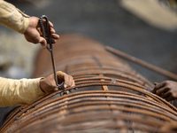 Migrated workers from India working at on-going Bridge expansion work supported by China AID at Tinkune, Kathmandu, Nepal on Thursday, March...