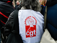 Striking Air France employees hold flags of French union CGT on March 12, 2018 in Paris, during a demonstration in front of the Palace of Ju...