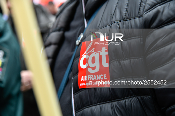 Striking Air France employees hold flags of French union CGT on March 12, 2018 in Paris, during a demonstration in front of the Palace of Ju...