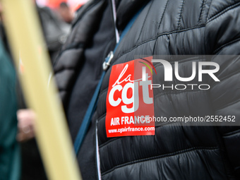 Striking Air France employees hold flags of French union CGT on March 12, 2018 in Paris, during a demonstration in front of the Palace of Ju...