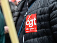 Striking Air France employees hold flags of French union CGT on March 12, 2018 in Paris, during a demonstration in front of the Palace of Ju...