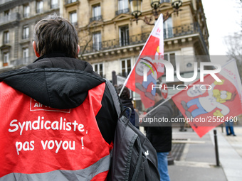 Striking Air France employees hold flags of French union CGT on March 12, 2018 in Paris, during a demonstration in front of the Palace of Ju...