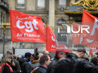 Striking Air France employees hold flags of French union CGT on March 12, 2018 in Paris, during a demonstration in front of the Palace of Ju...