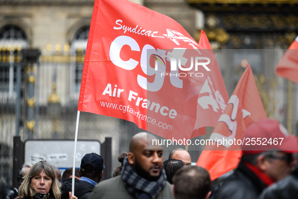 Striking Air France employees hold flags of French union CGT on March 12, 2018 in Paris, during a demonstration in front of the Palace of Ju...