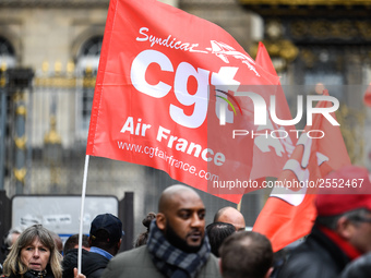 Striking Air France employees hold flags of French union CGT on March 12, 2018 in Paris, during a demonstration in front of the Palace of Ju...